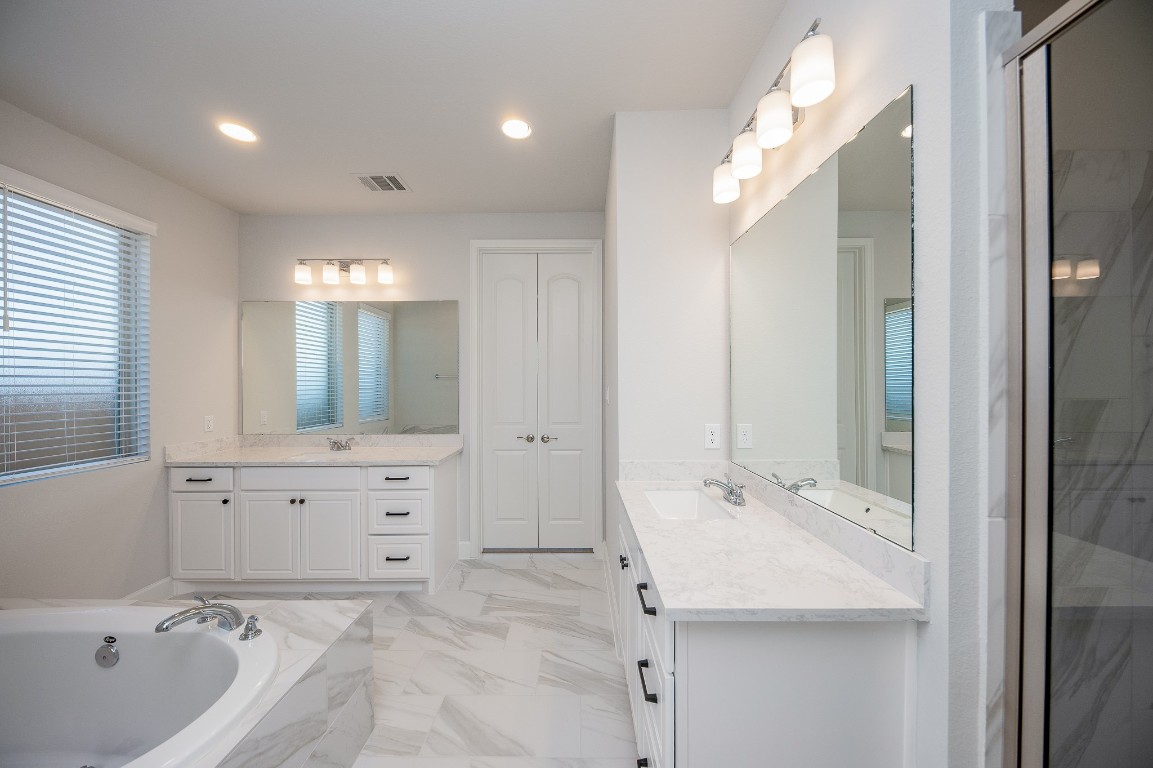 29819 Breezy Pnes Loop Fulshear, TX 77441 - Photo 41 of 50 a bathroom with a bathtub sink and mirror