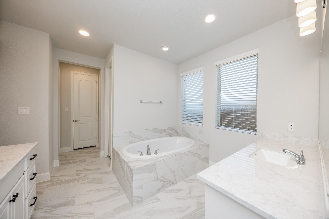 29819 Breezy Pnes Loop Fulshear, TX 77441 - Photo 42 of 50 a bathroom with a bathtub and a sink