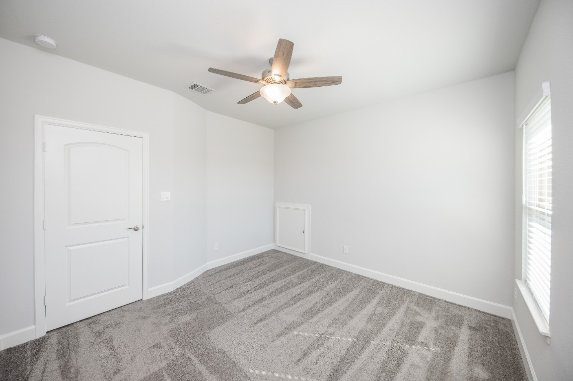 29819 Breezy Pnes Loop Fulshear, TX 77441 - Photo 44 of 50 an empty room with windows and fan