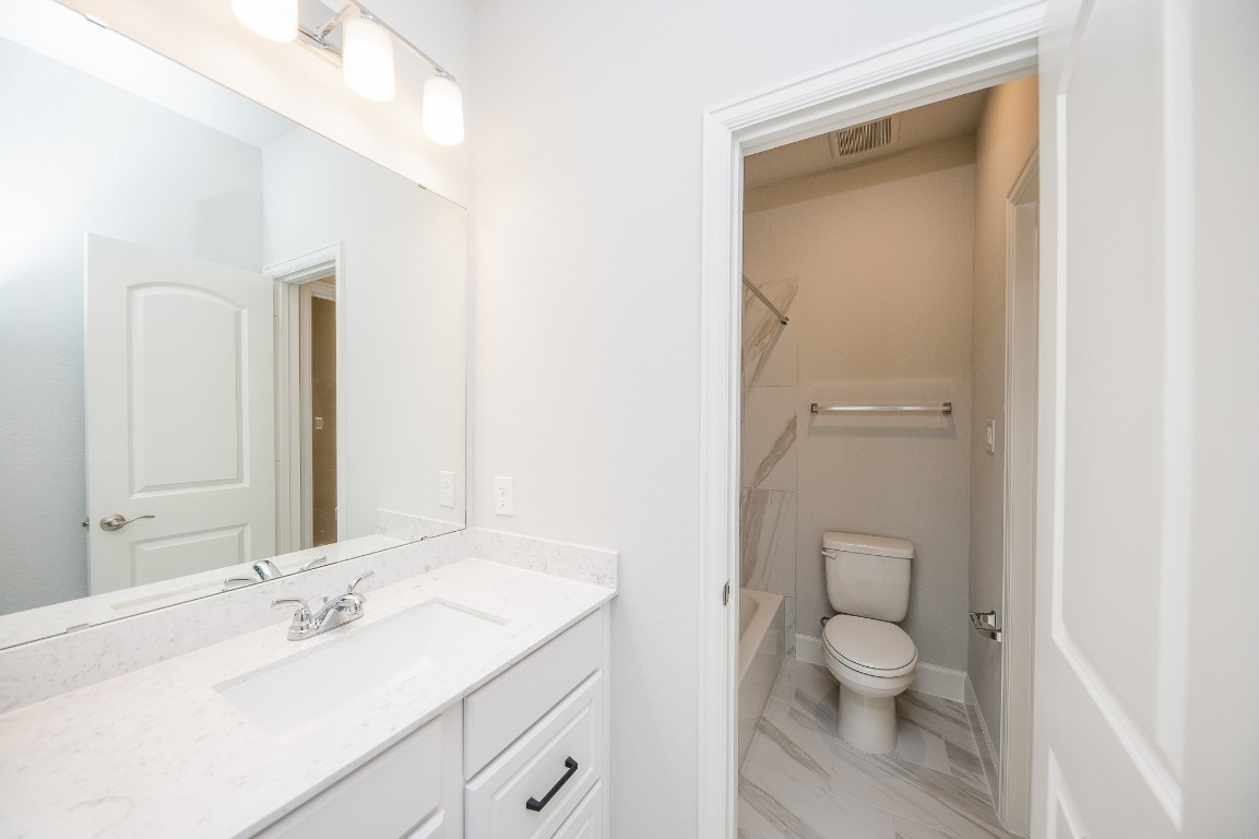 29819 Breezy Pnes Loop Fulshear, TX 77441 - Photo 45 of 50 a bathroom with a sink a toilet and a mirror
