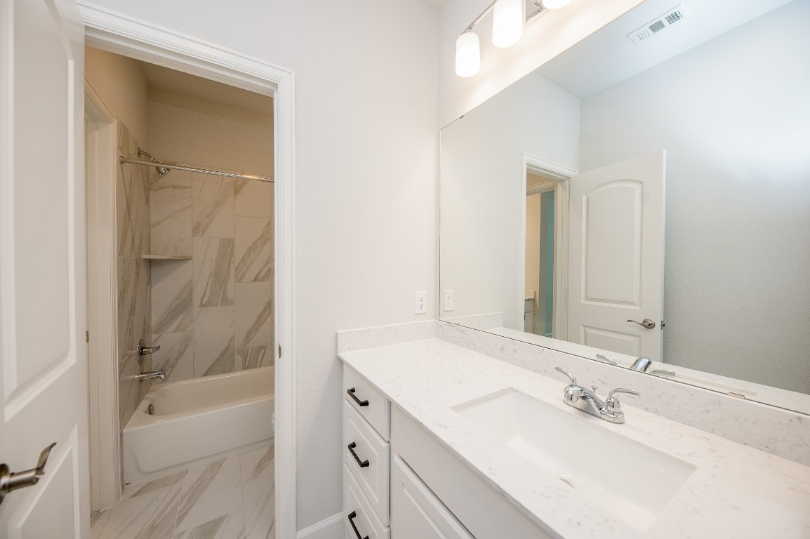 29819 Breezy Pnes Loop Fulshear, TX 77441 - Photo 46 of 50 a bathroom with a bathtub shower sink vanity and mirror