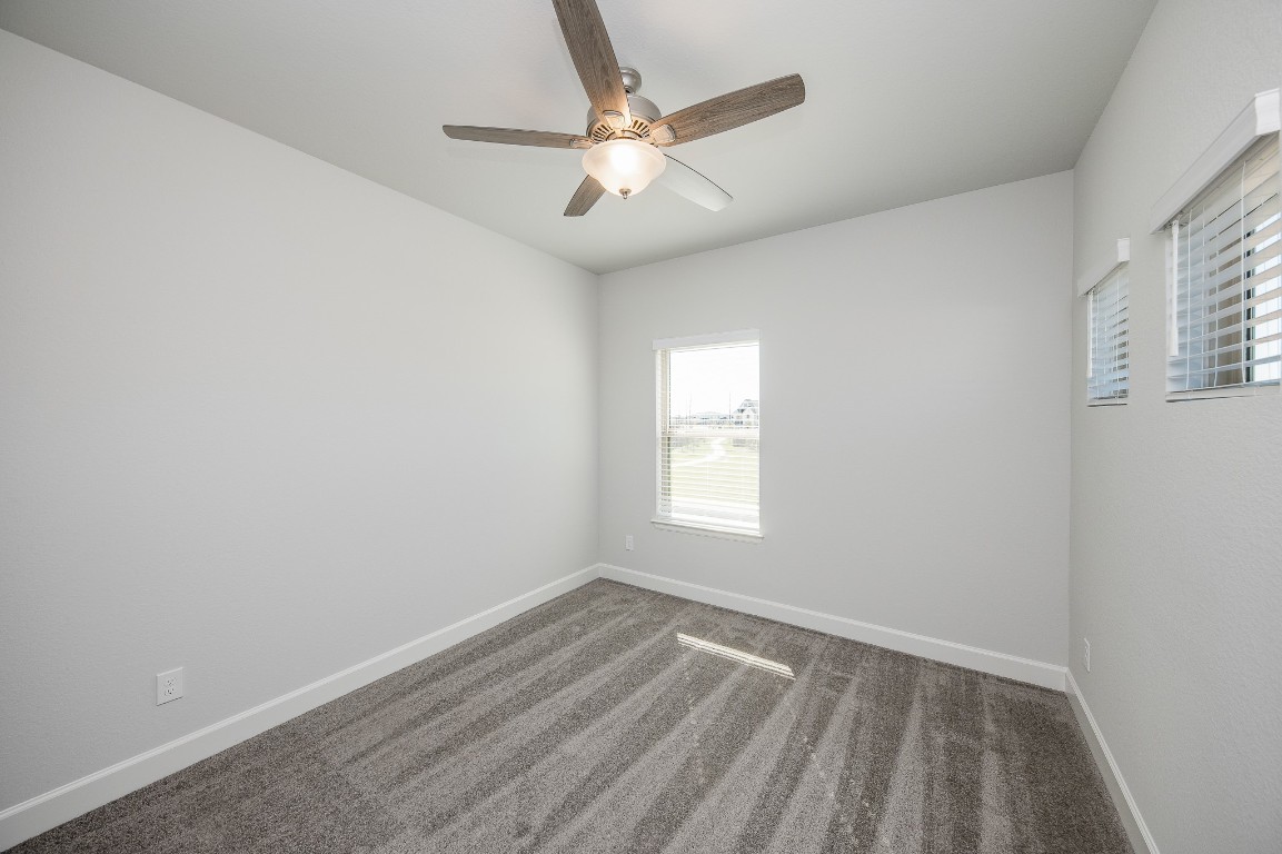 29819 Breezy Pnes Loop Fulshear, TX 77441 - Photo 47 of 50 an empty room with a window and a fan