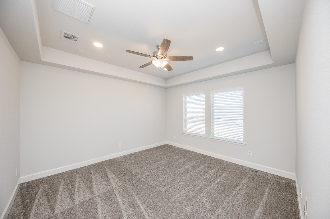 29819 Breezy Pnes Loop Fulshear, TX 77441 - Photo 50 of 50 an empty room with windows and ceiling fan