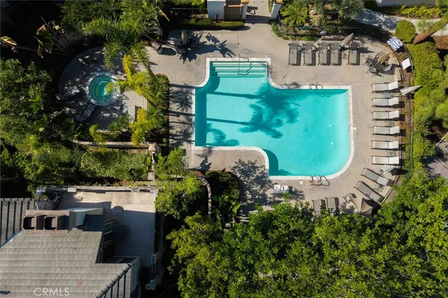 an aerial view of a house with outdoor space pool seating area and yard
