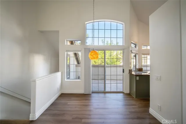 an empty room with cabinet and wooden floor