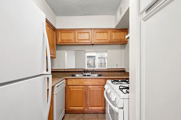 a kitchen with stainless steel appliances granite countertop a stove and a microwave