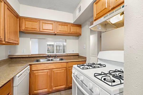 a kitchen with stainless steel appliances granite countertop a stove and a sink