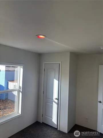 a view of a room with wooden floor and staircase