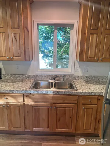 a kitchen with granite countertop a sink and a window