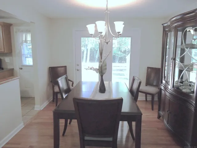 a view of a dining room with furniture window and wooden floor