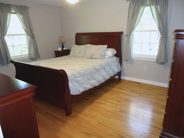 a bedroom with a bed and window