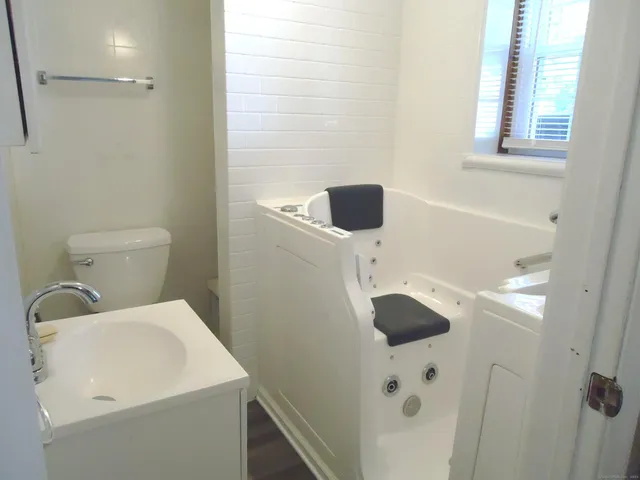 a bathroom with a toilet sink and shower