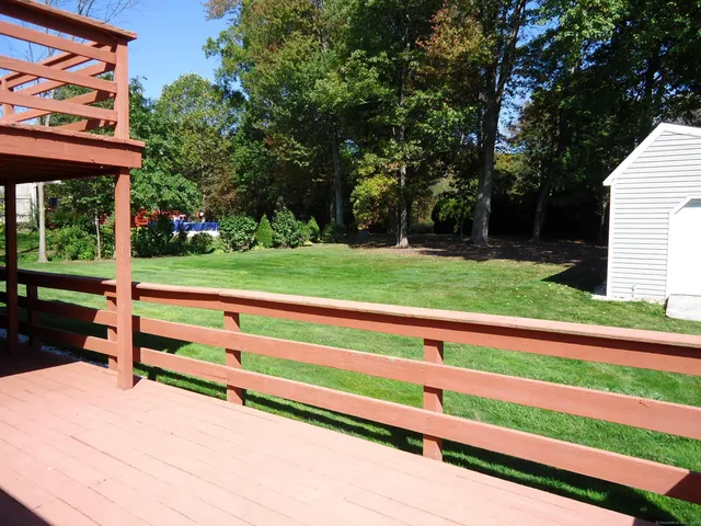 a view of a wooden deck and a big yard