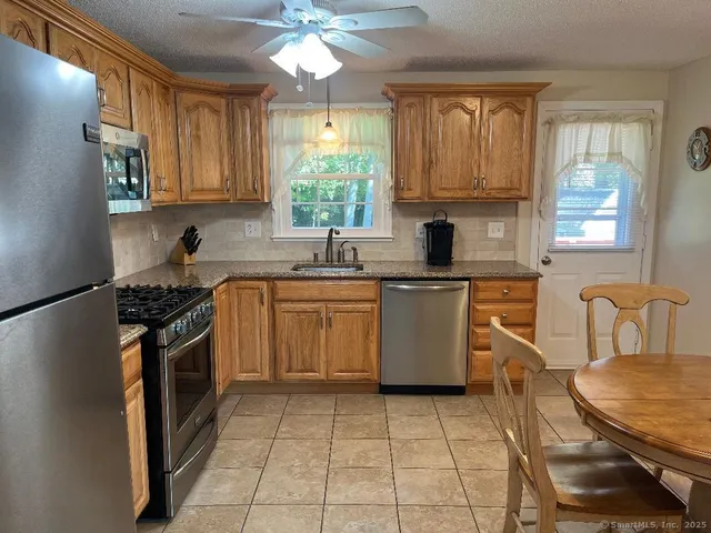 a kitchen with a stove sink and cabinets