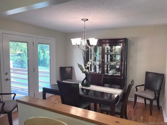 a living room with furniture chandelier and a window