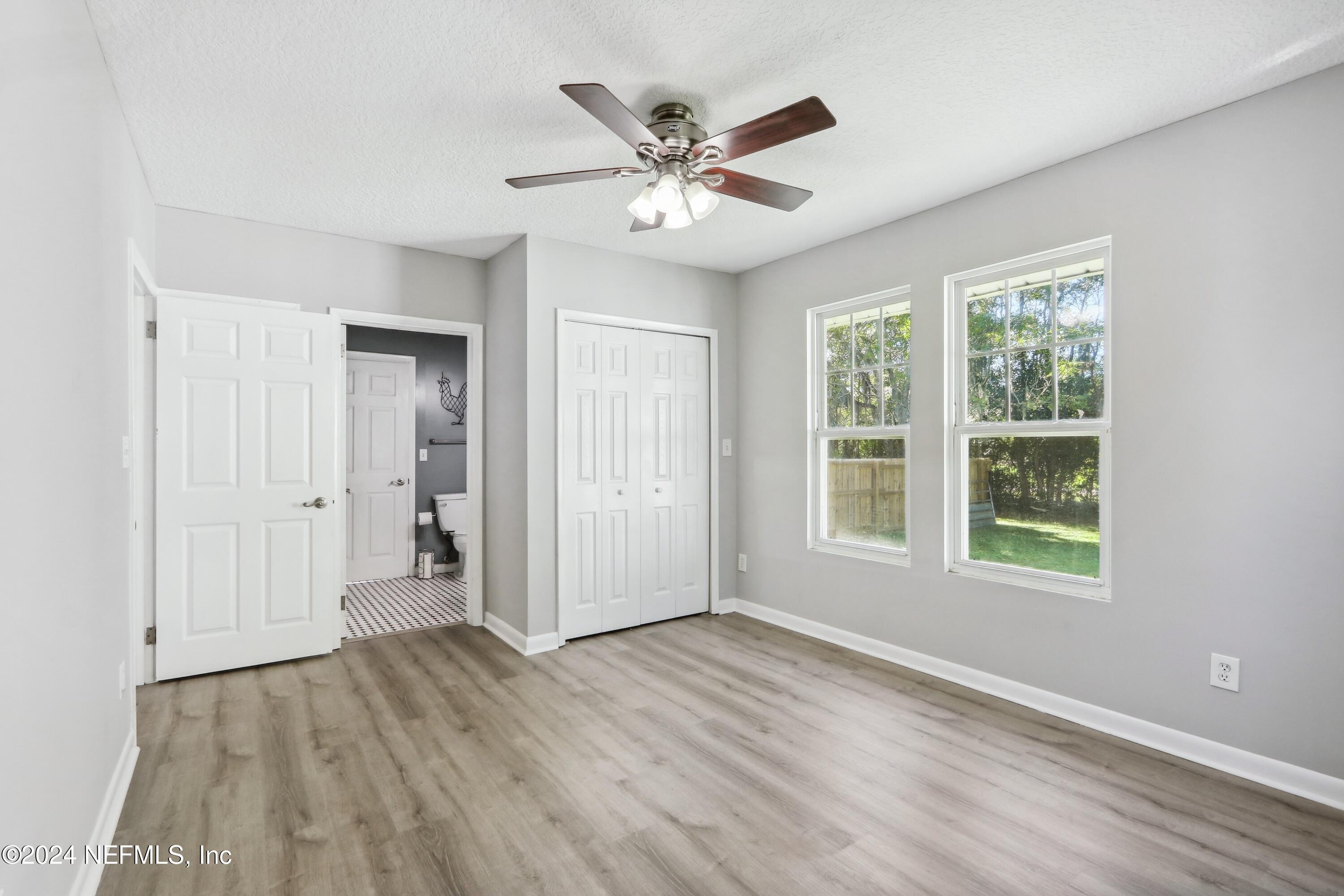 3629 Capper Road Jacksonville, FL 32218 - Photo 12 of 26 a view of an empty room with wooden floor and a window