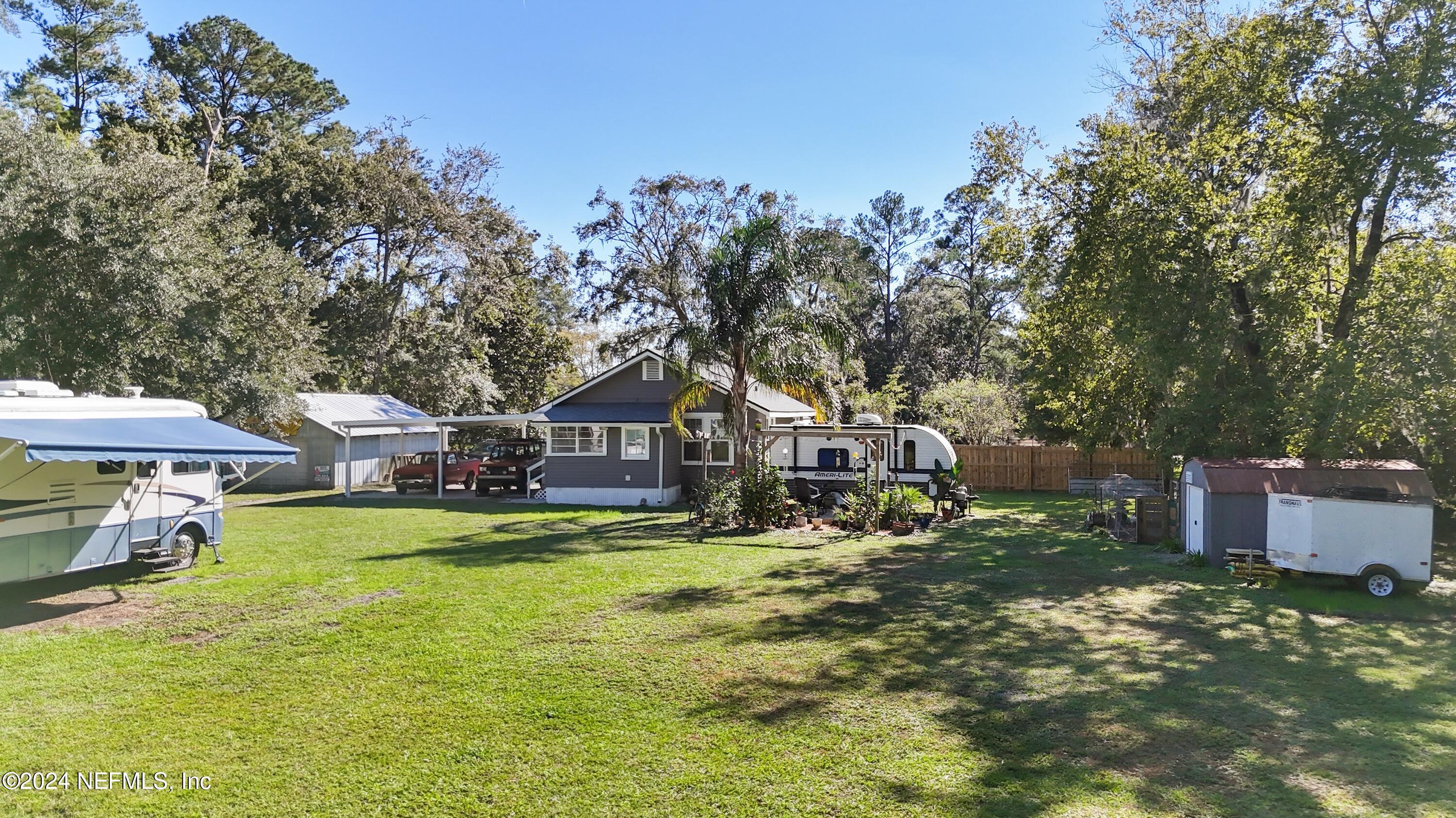 3629 Capper Road Jacksonville, FL 32218 - Photo 18 of 26 a view of a house with a yard patio and fire pit