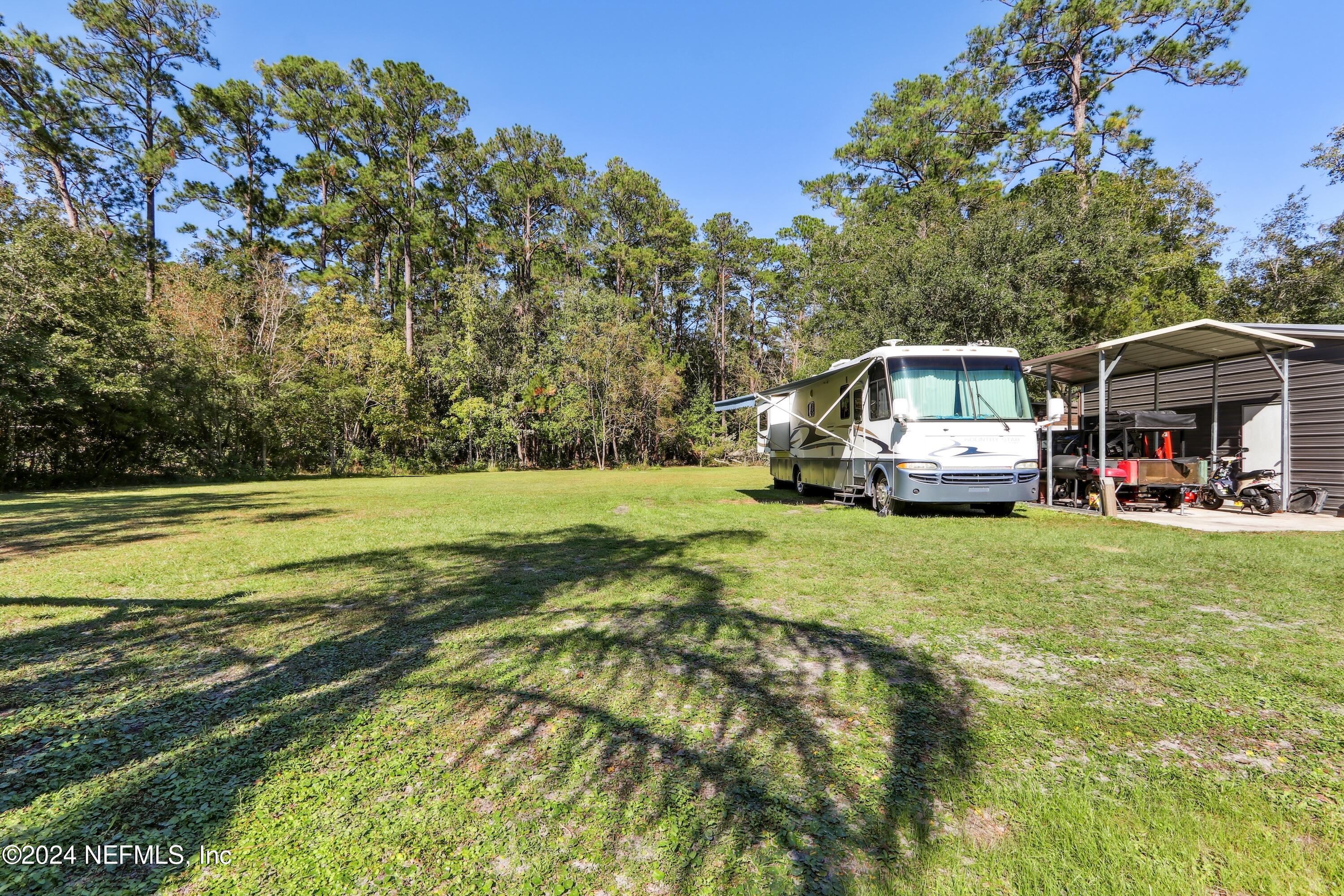 3629 Capper Road Jacksonville, FL 32218 - Photo 19 of 26 a view of a house with a big yard