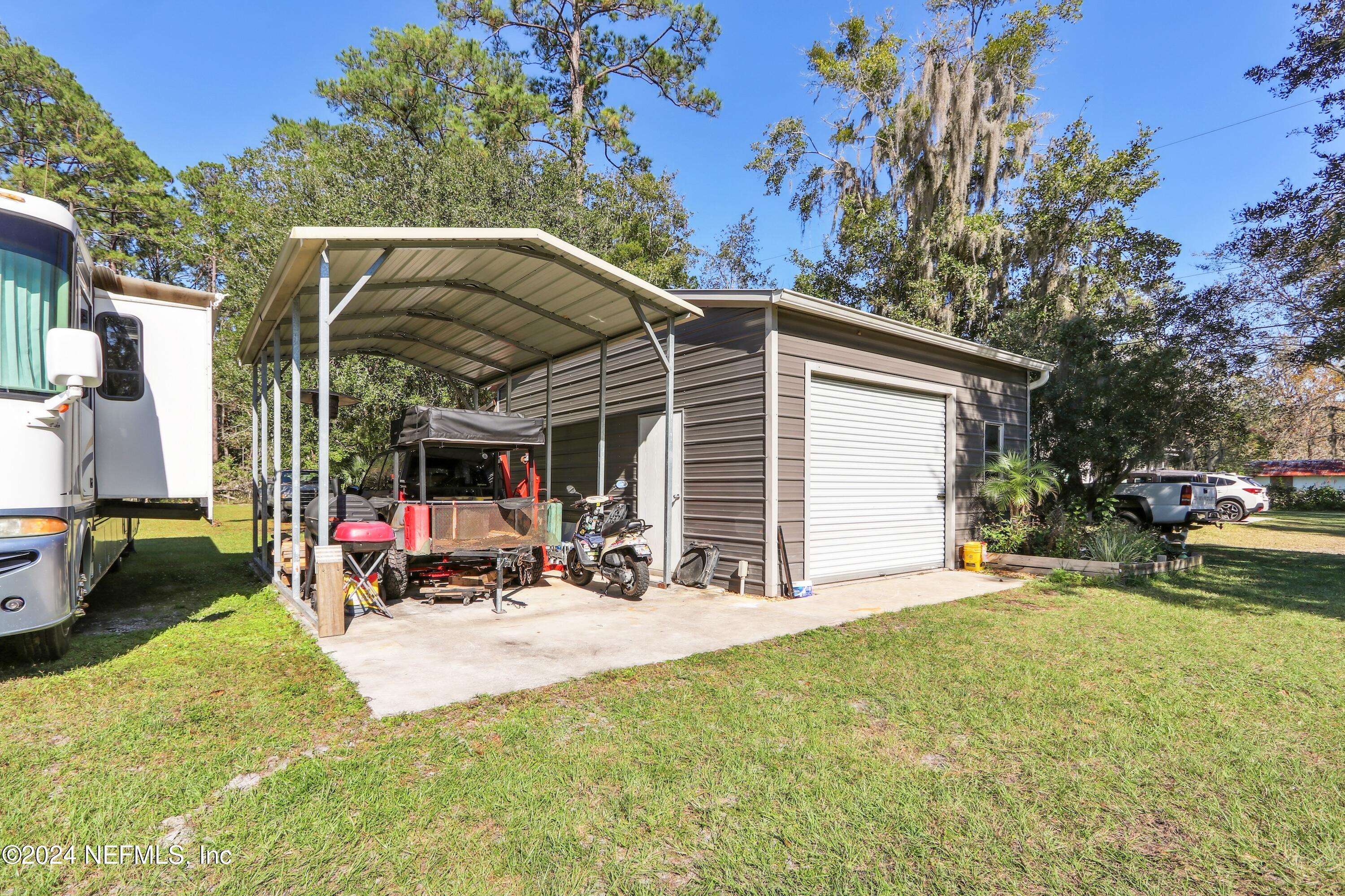 3629 Capper Road Jacksonville, FL 32218 - Photo 20 of 26 a view of a house with a patio and a yard