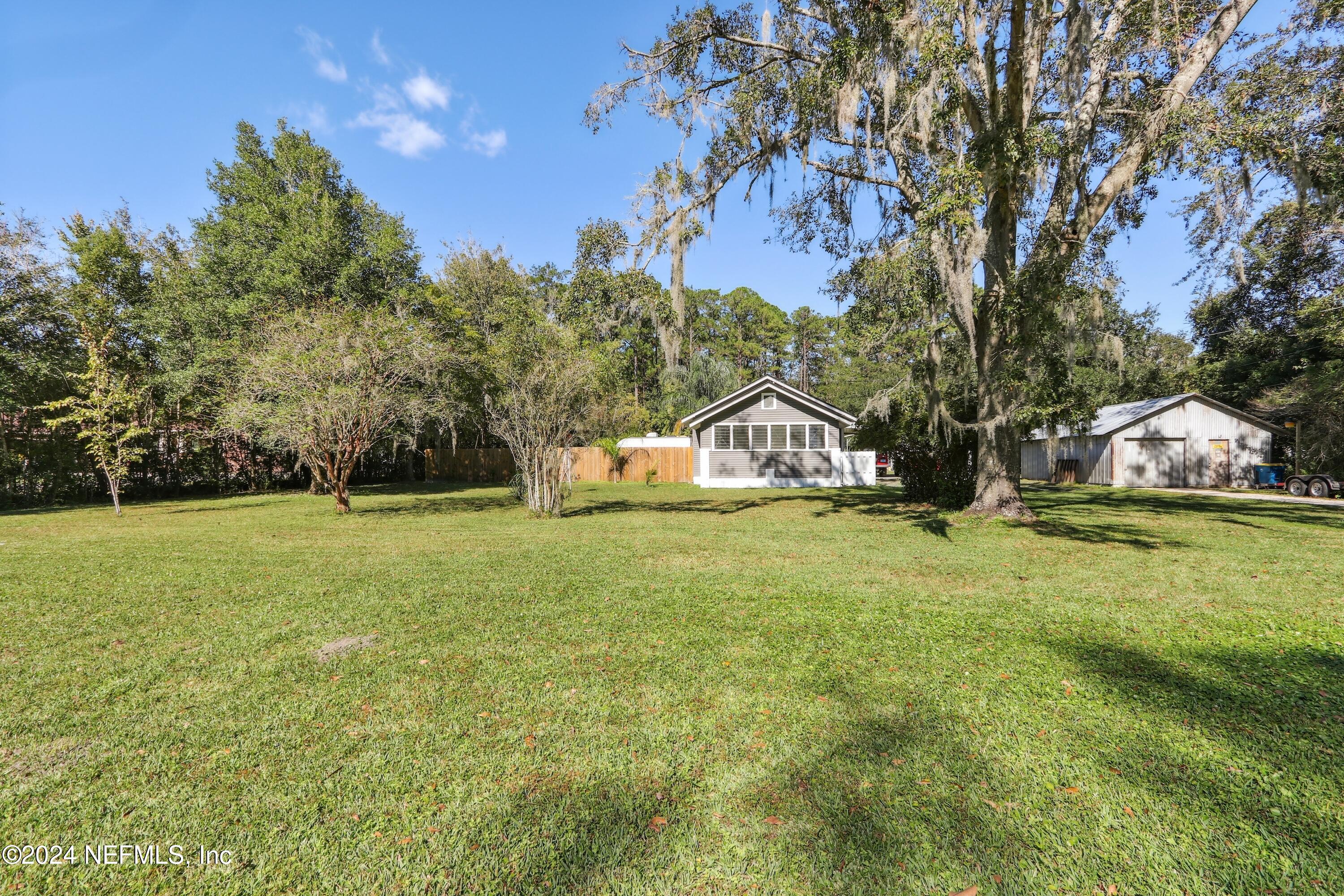 3629 Capper Road Jacksonville, FL 32218 - Photo 2 of 26 a house with trees in the background