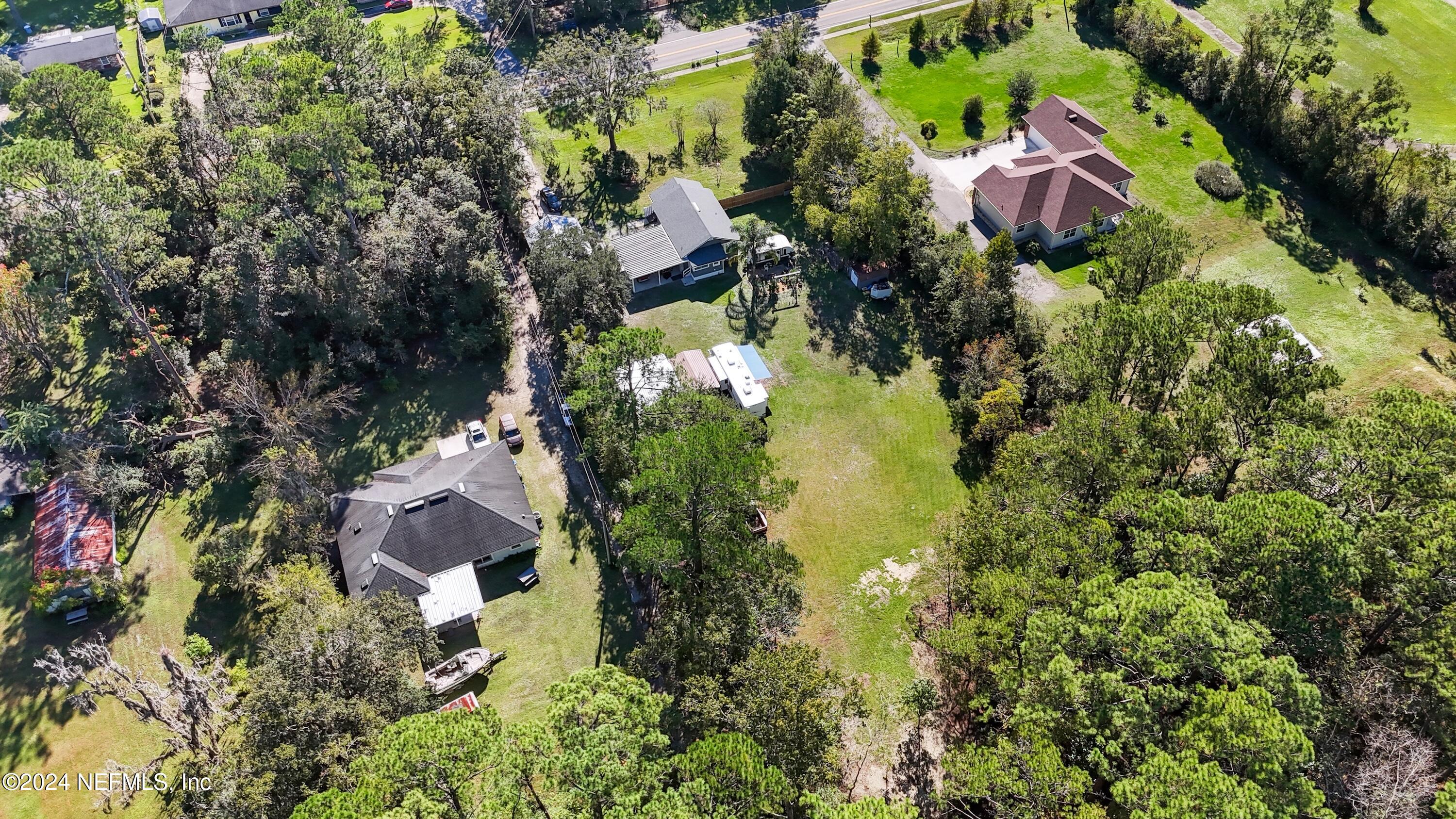 3629 Capper Road Jacksonville, FL 32218 - Photo 24 of 26 an aerial view of residential house with swimming pool and lawn chairs