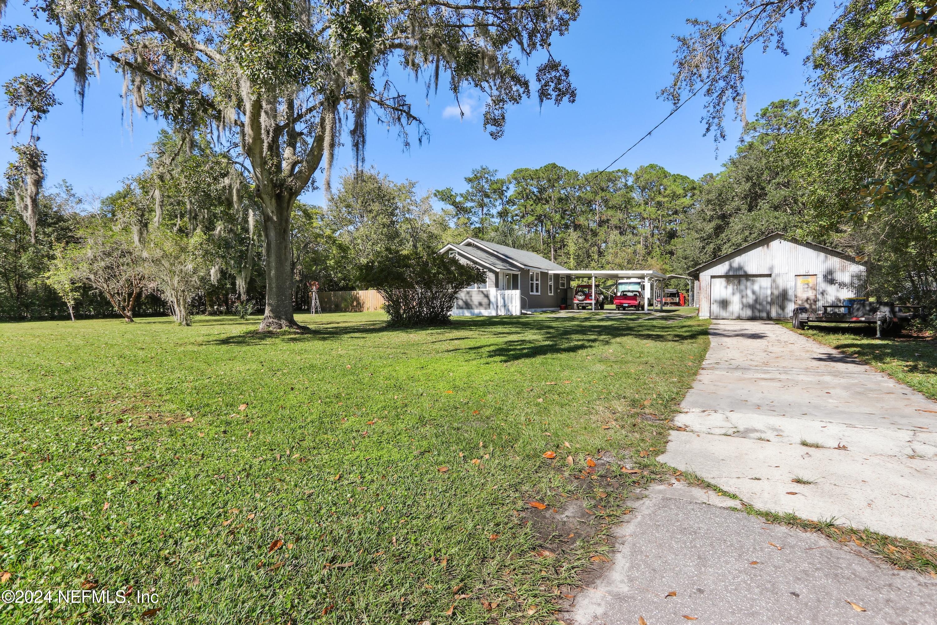 3629 Capper Road Jacksonville, FL 32218 - Photo 3 of 26 a view of a house with a big yard
