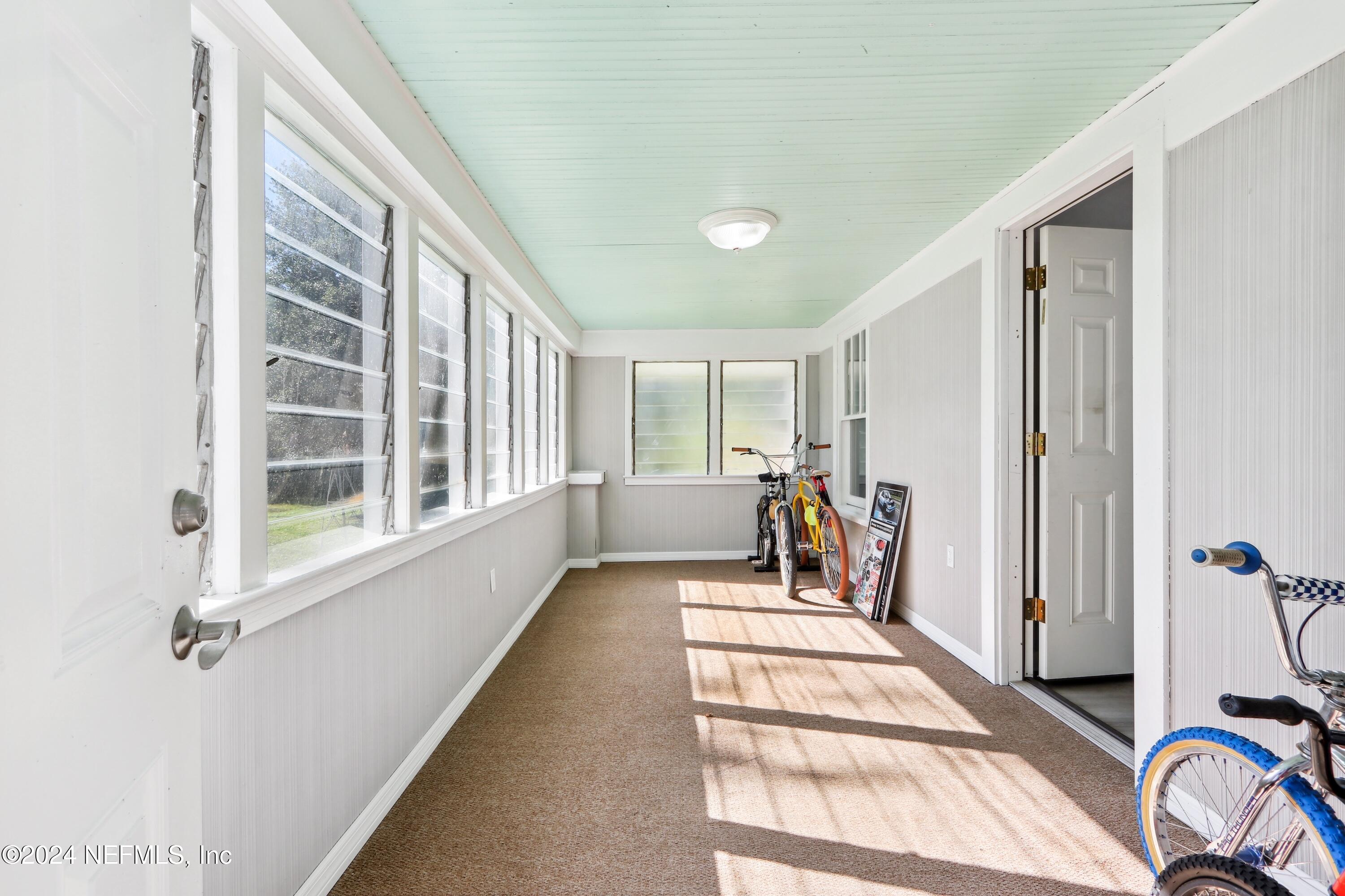 3629 Capper Road Jacksonville, FL 32218 - Photo 4 of 26 a view of a hallway with a couch and a window