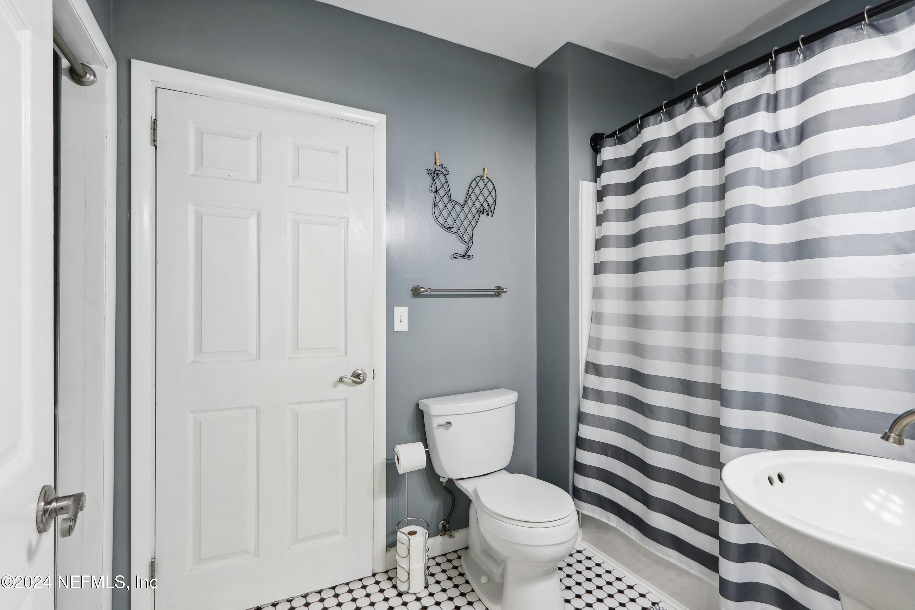 3629 Capper Road Jacksonville, FL 32218 - Photo 10 of 26 a bathroom with a toilet a sink and a shower