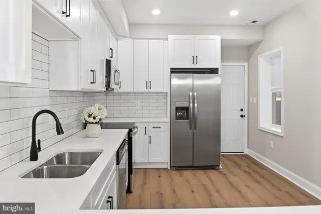 a kitchen with stainless steel appliances granite countertop a refrigerator sink and cabinets