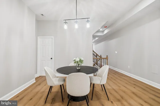 a dining room with furniture and wooden floor