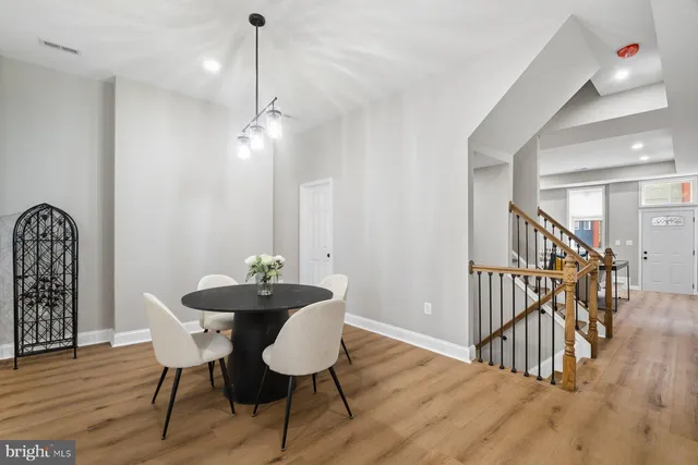 a dining room with furniture and wooden floor