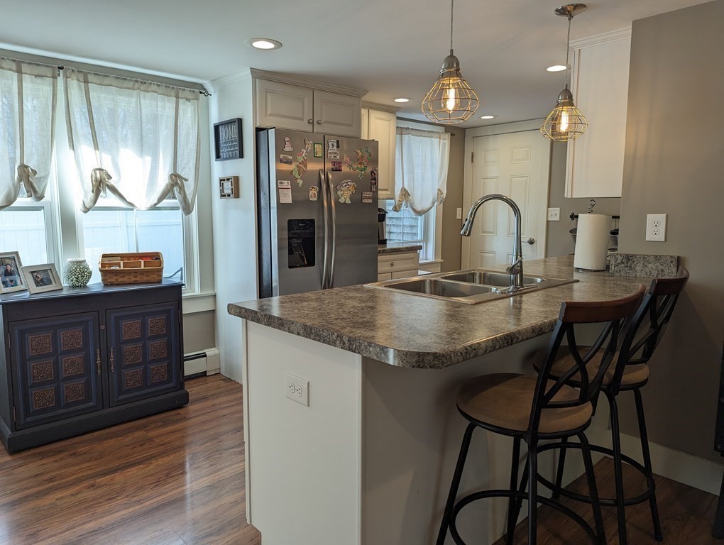 622 Turnpike Road New Ipswich, NH 03071 - Photo 8 of 30 a kitchen with stainless steel appliances granite countertop a kitchen island a stove and a wooden cabinets