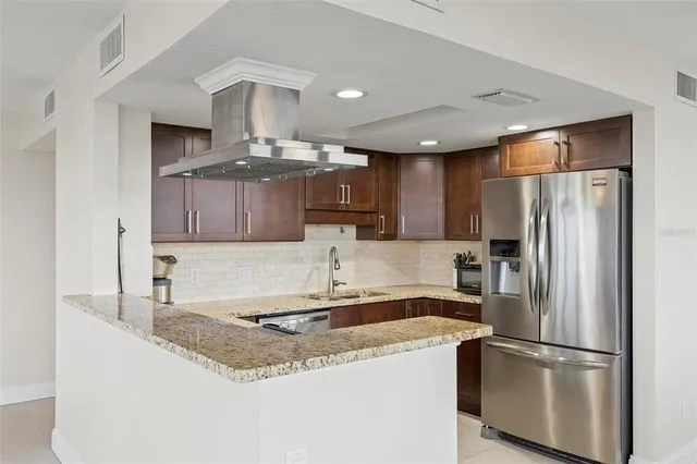 a kitchen with sink cabinets and stainless steel appliances