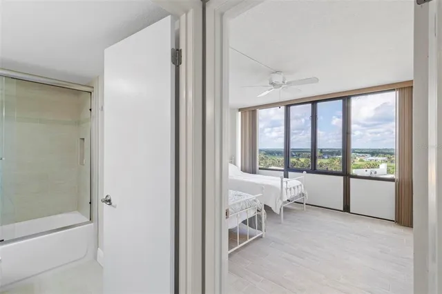 a bathroom with a granite countertop sink a toilet a mirror and shower