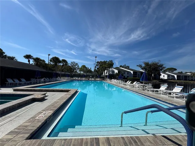 a view of a swimming pool with chairs