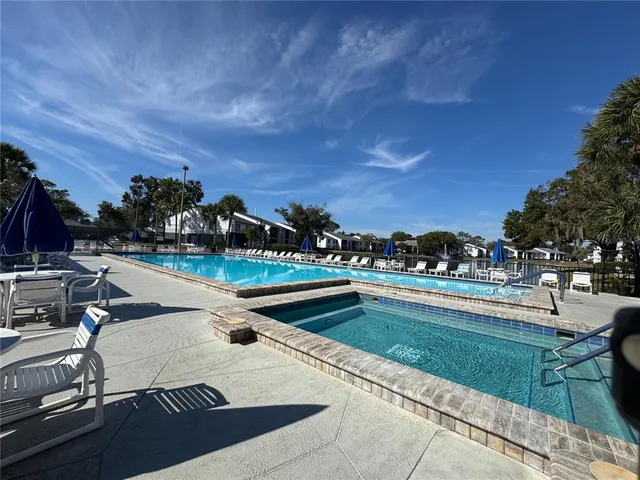 a view of swimming pool with outdoor seating and plants