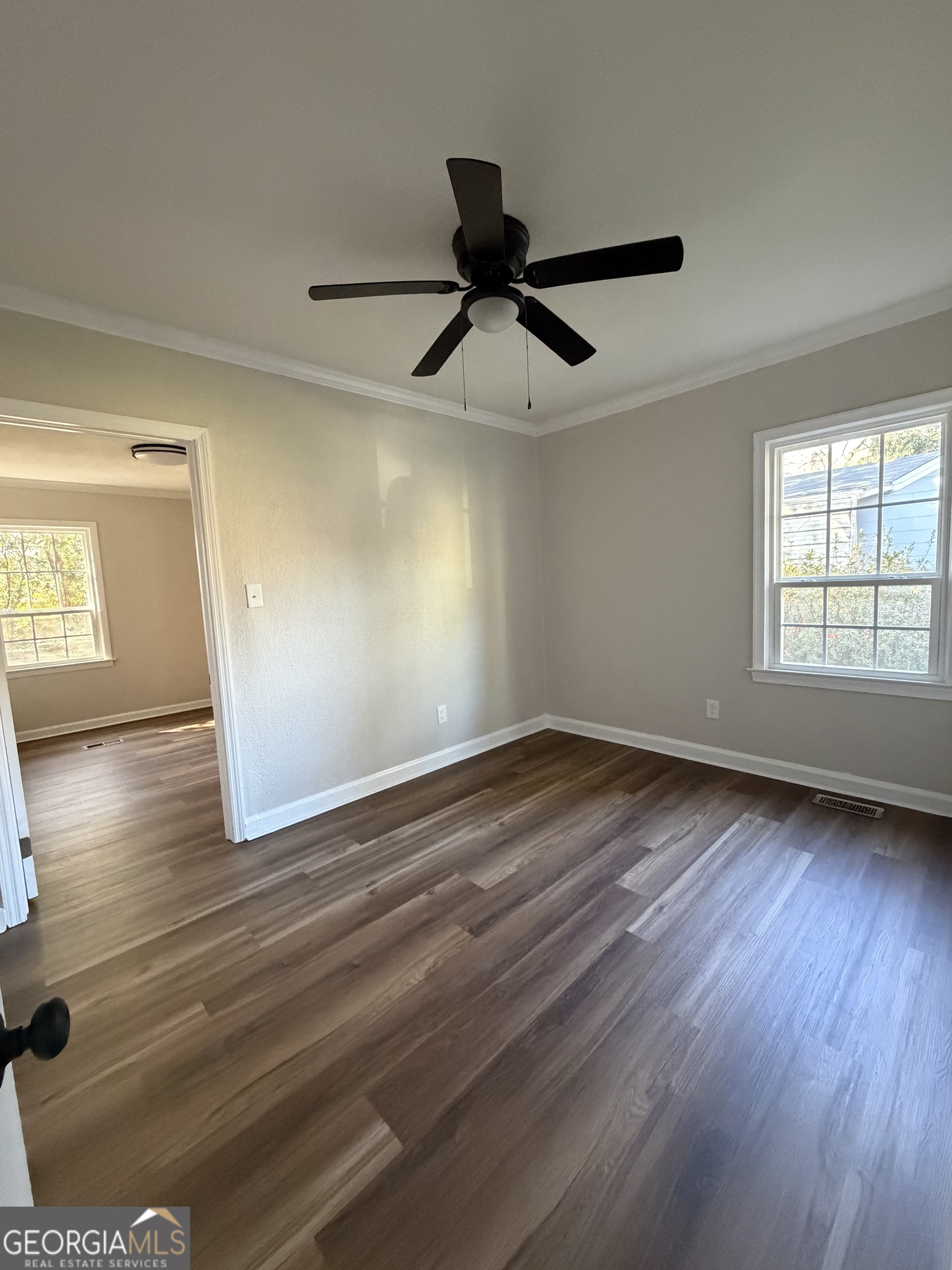 1502 Stonewall Street Dublin, GA 31021 - Photo 10 of 24 a view of empty room with wooden floor and fan