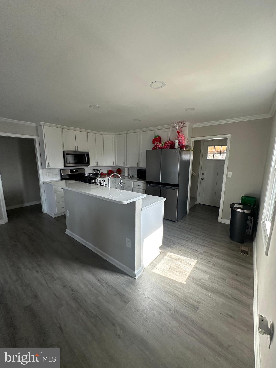 4427 Annapolis Road Halethorpe, MD 21227 - Photo 11 of 36 a kitchen with a sink cabinets and wooden floor
