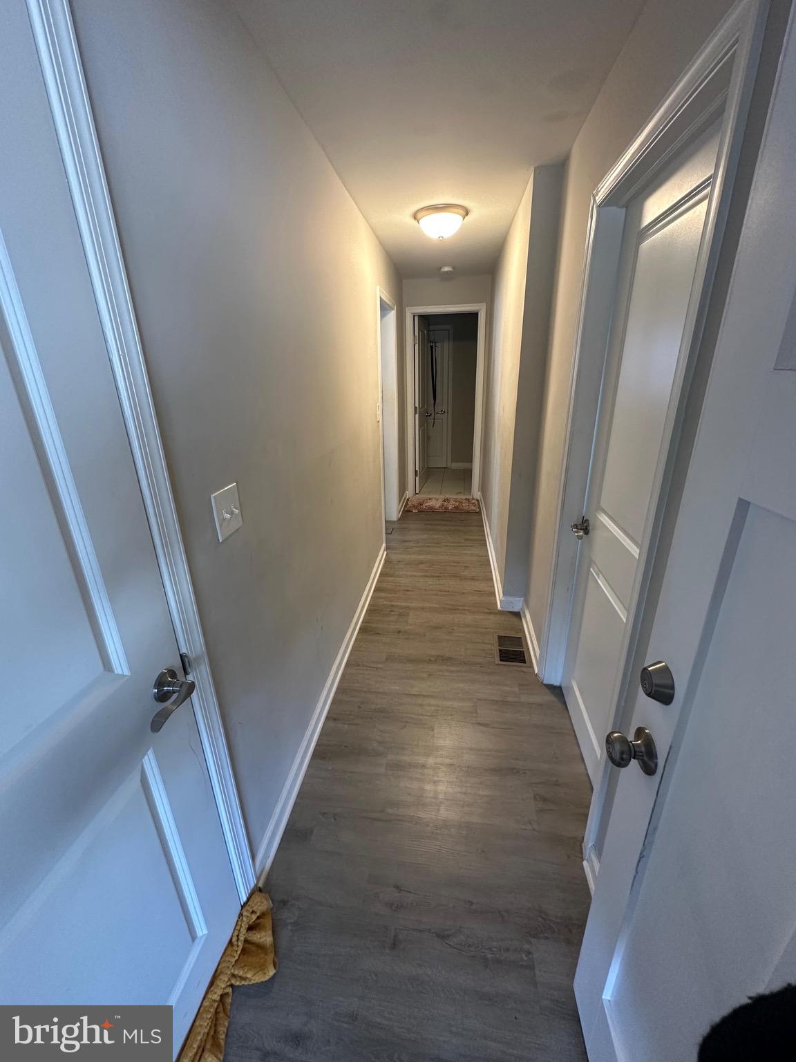 4427 Annapolis Road Halethorpe, MD 21227 - Photo 33 of 36 a view of a hallway with wooden floor and staircase