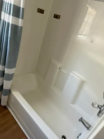 a bathroom with a bathtub and a shower