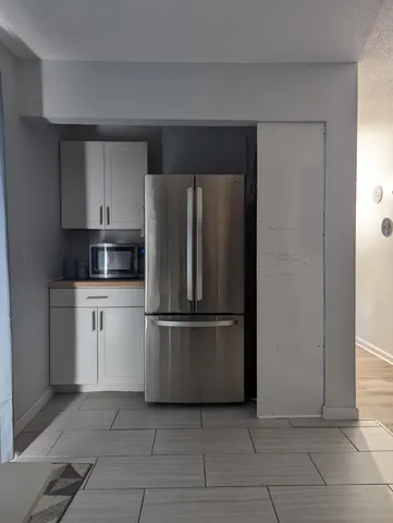 a kitchen with a refrigerator and cabinets