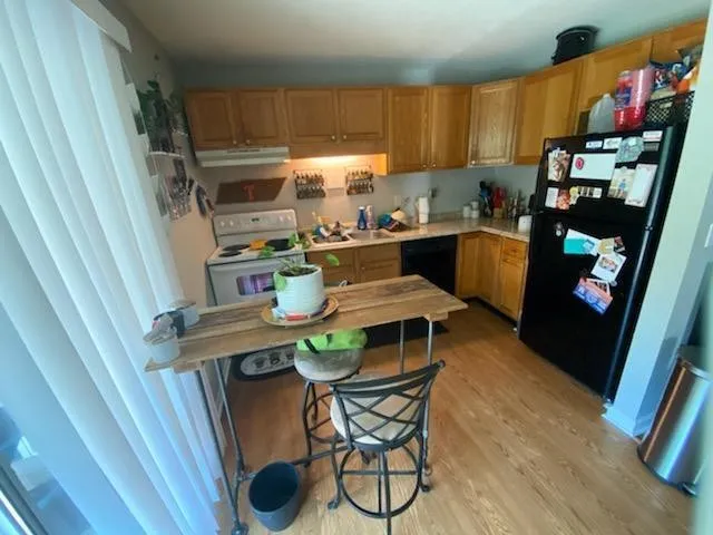 a kitchen with a table chairs a stove a microwave and cabinets
