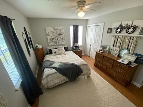 a bedroom with a bed couch and window