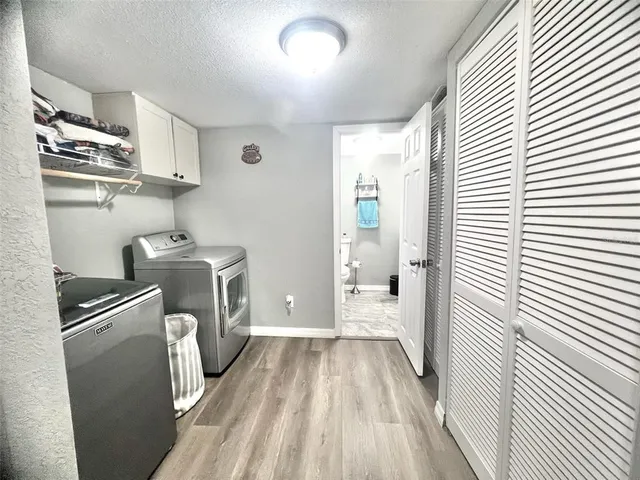 a utility room with sink dryer and washer