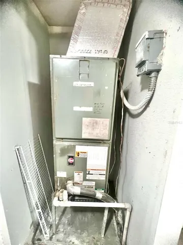 a view of a patio with table and chairs under an umbrella