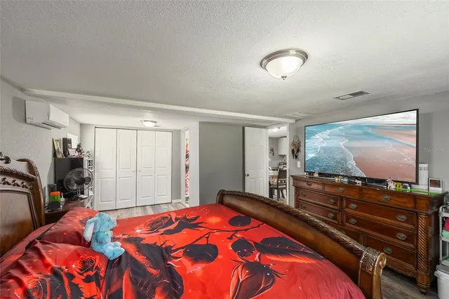 a view of a house with a big yard potted plants and large tree