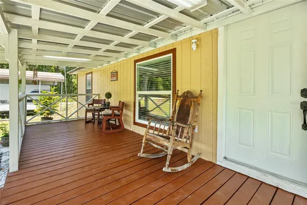a view of a room with wooden floor and outdoor seating