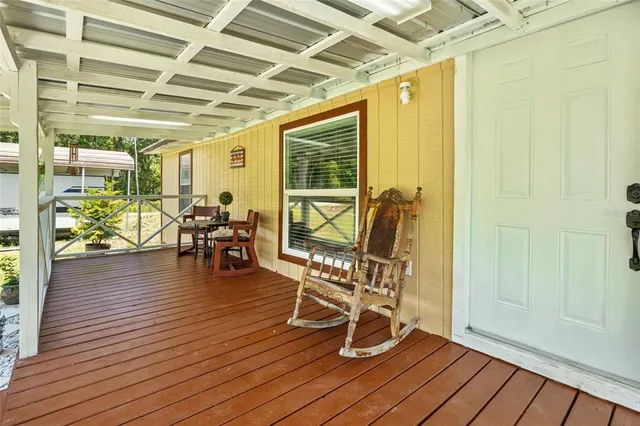 a view of a room with wooden floor and outdoor seating