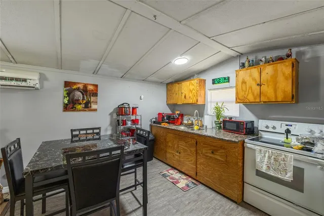an aerial view of residential house with outdoor space and trees all around