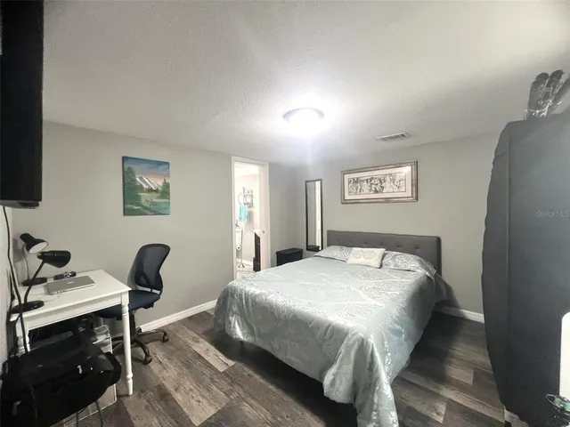 a large kitchen with a lot of counter space and wooden floor